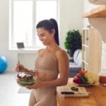 Slender,Fitness,Woman,In,Sportswear,Standing,At,Home,In,The
