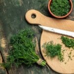 Chopped,Fresh,Dill,On,A,Cutting,Board,And,A,Bunch