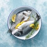 Fresh,Raw,Dorado,Fish,Cooking,With,Lemon,And,Rosemary.,Sea