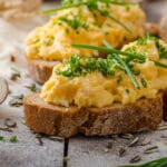 Scrambled,Eggs,With,Herbs,On,Wheat-rye,Crispy,Bread,,Homemade