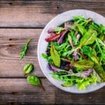 Fresh,Salad,With,Mixed,Greens,In,Bowl,On,Wooden,Background